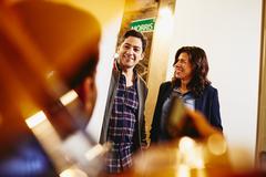 two people standing in a door opening talking to a colleague