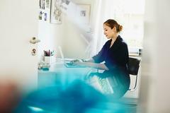 A woman working from home on her laptop.
