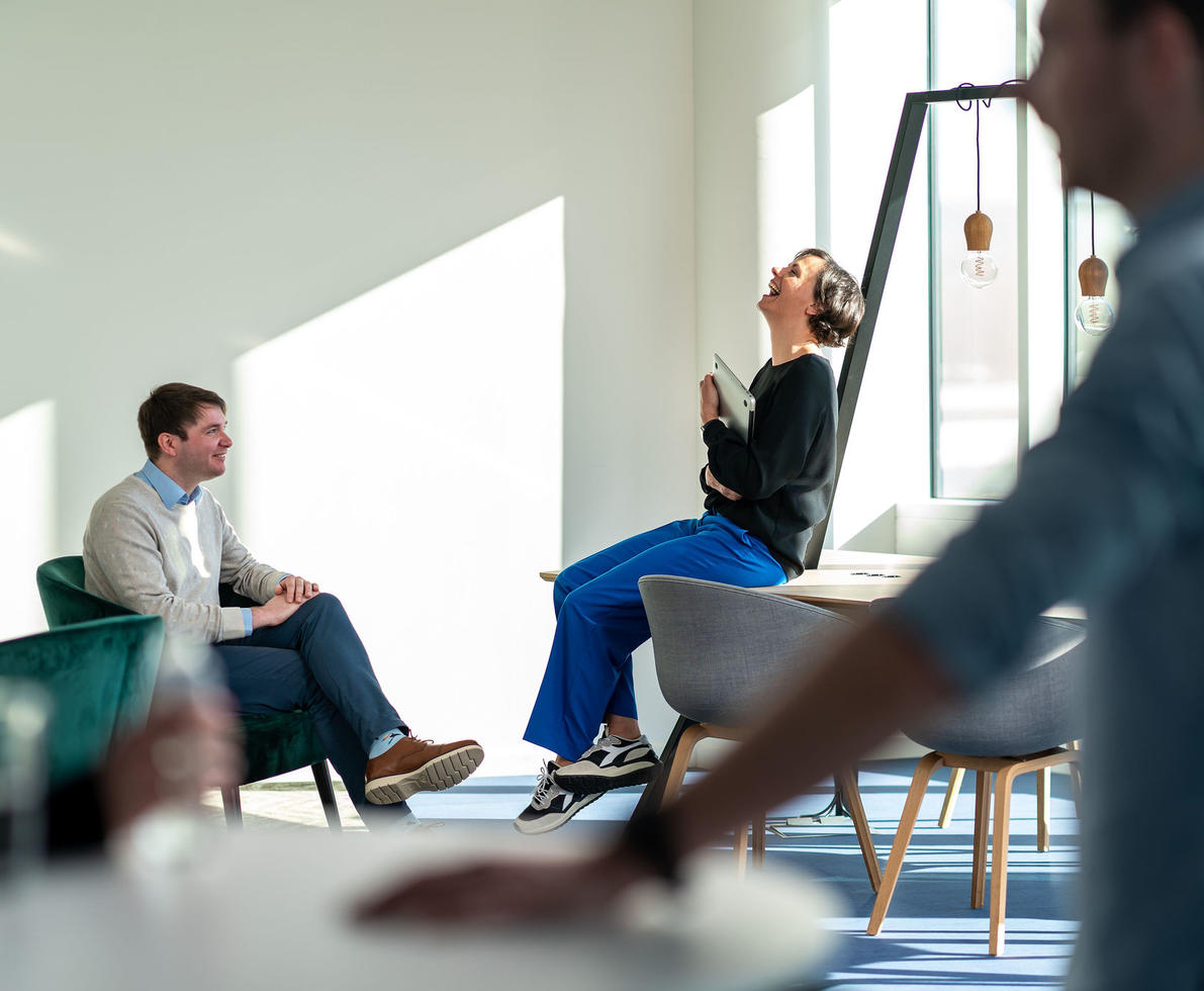 colleagues in a meeting, laughing